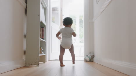 happy baby girl learning to walk toddler exploring home curious infant walking through house enjoying childhood