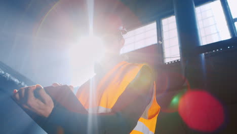 An-engineer-works-in-a-warehouse-and-uses-a-tablet-10