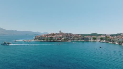 flying towards korcula medieval old town in croatia - aerial drone shot