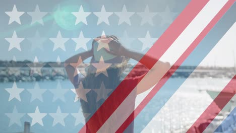 american flag design pattern and multiple stars against rear view of woman standing on a wooden pier