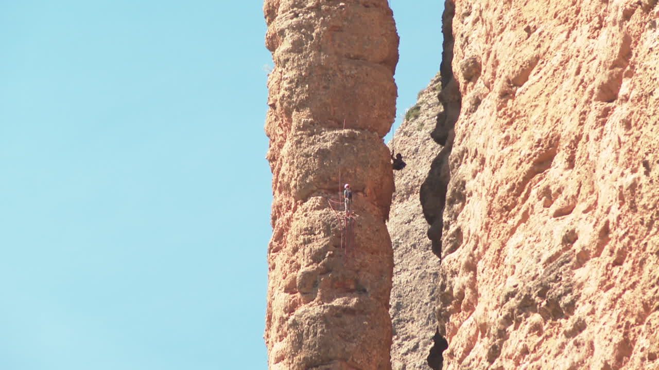Rock Climber Ascending a Steep Rock Face