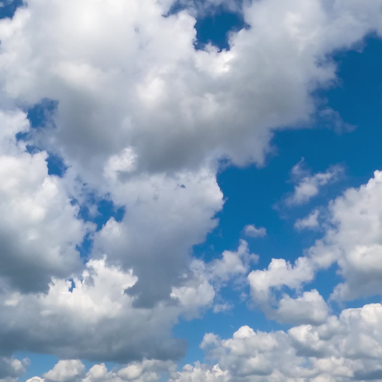 Wonderful cumulus cotton clouds moving by the sky. Timelapse. Sunny bright day backdrop