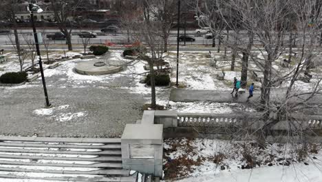 people strolling and jogging in a park, post winter