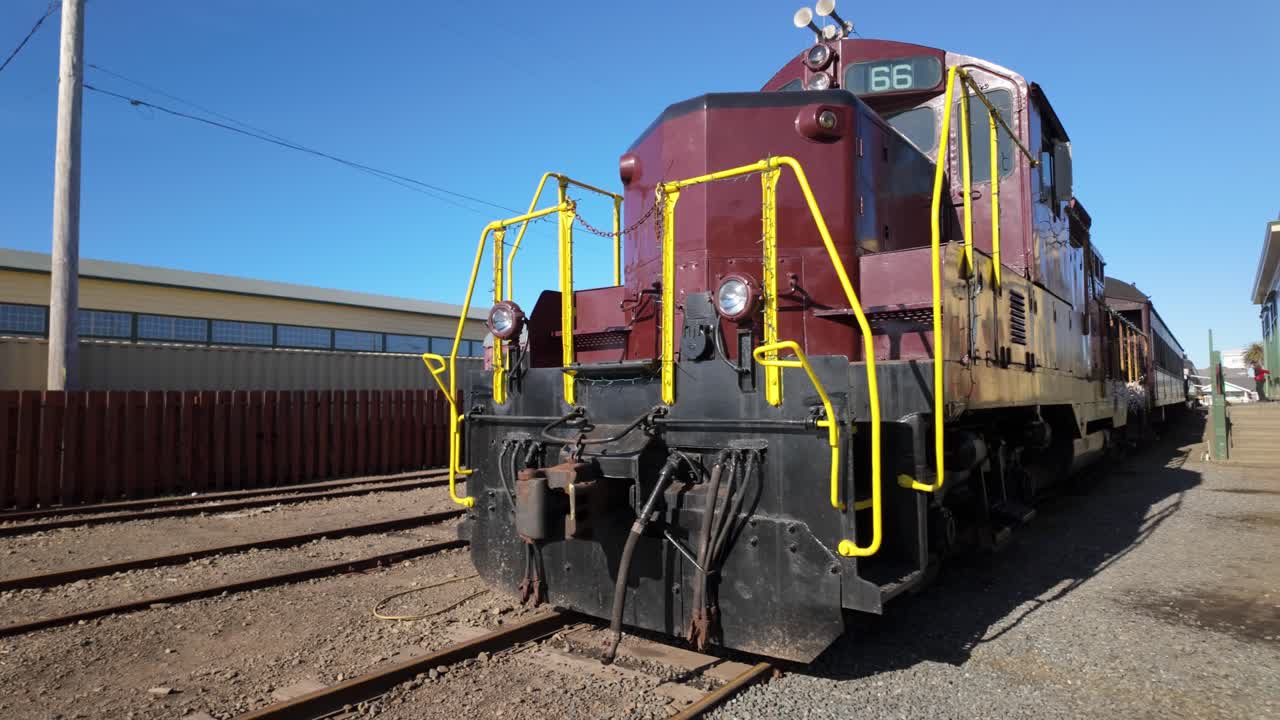 Gimbal wide panning shot of the historic Skunk Train engine in downtown Fort Bragg, California. 4K