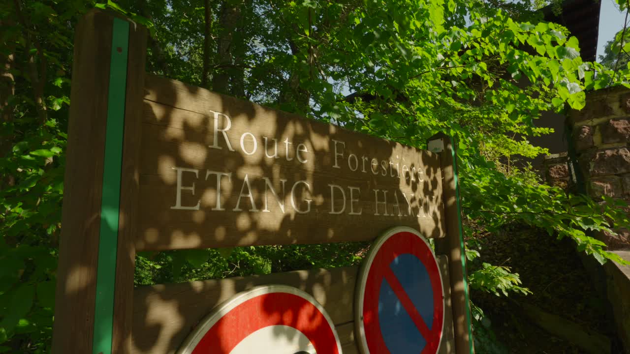 Entrance sign for a forest hiking route through the natural reserve of &Eacute;tang de Hanau