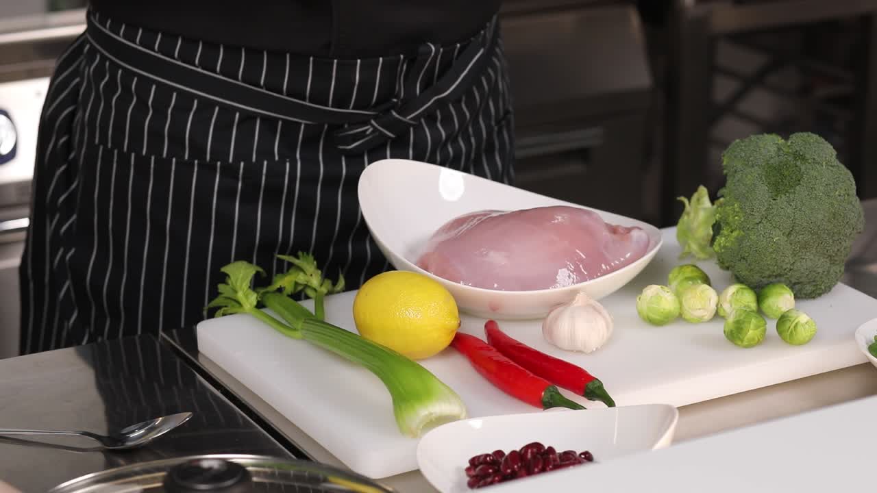 Chef preparing a meal with turkey breast and vegetables