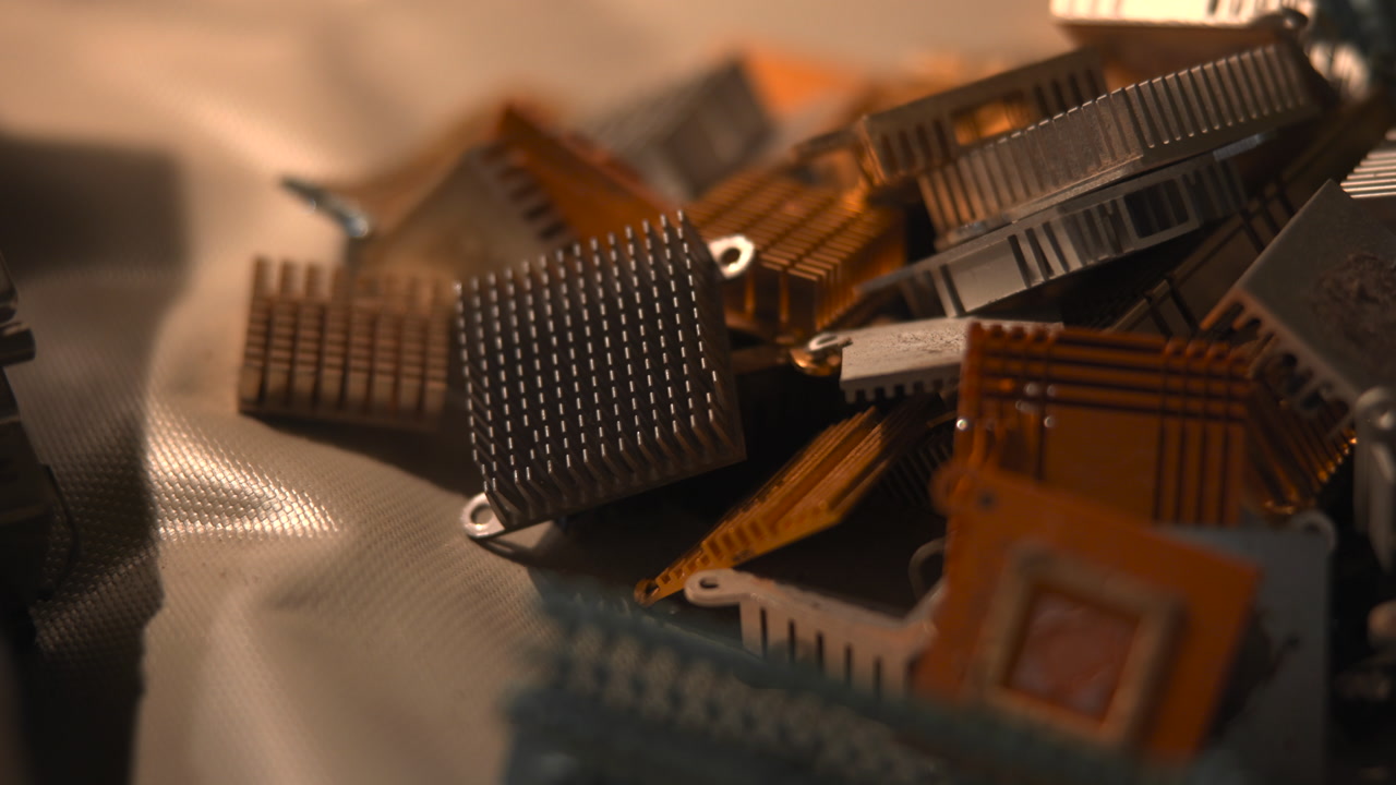 Closeup Pile Electronic Components Warm Lighting Microchips And Heatsinks Tangled On Fabric Shallow Depth . Media