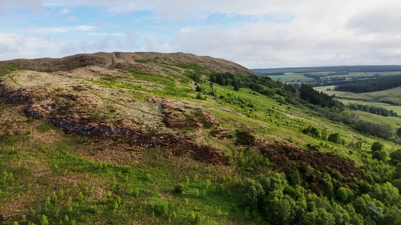 Drone flying close to rocky hilltop path