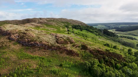 drone flying close to rocky hilltop path