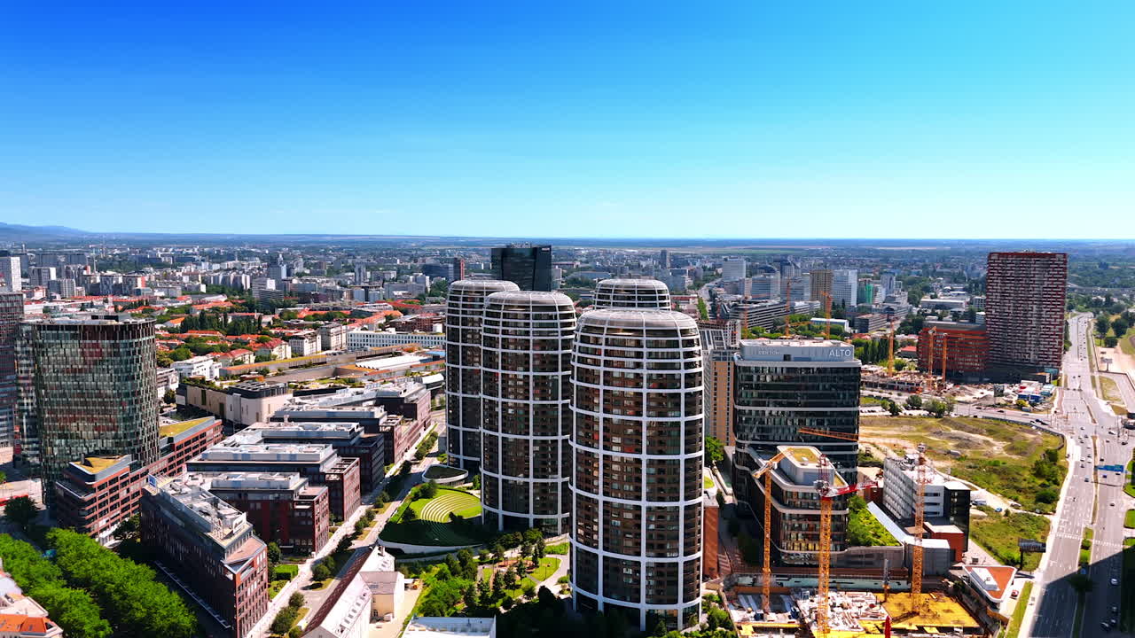 Bratislava's urban skyline. View of Bratislava's modern skyline showcasing unique buildings and green spaces under a clear blue sky