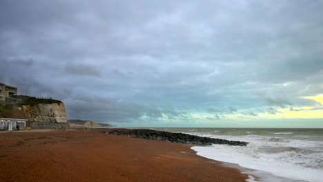 Vista-A-Lo-Largo-De-La-Playa-De-Guijarros-En-Rottingdean,-Inglaterra,-A-Lo-Largo-De-La-Costa-Y-Los-Acantilados-Blancos-De-Dover