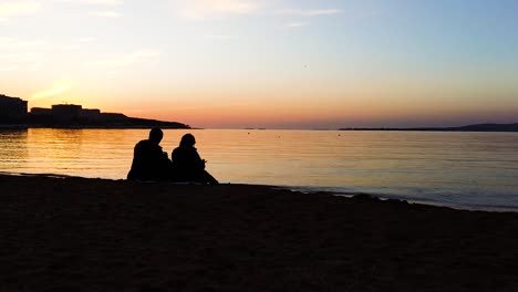 couple watching sunset on the beach