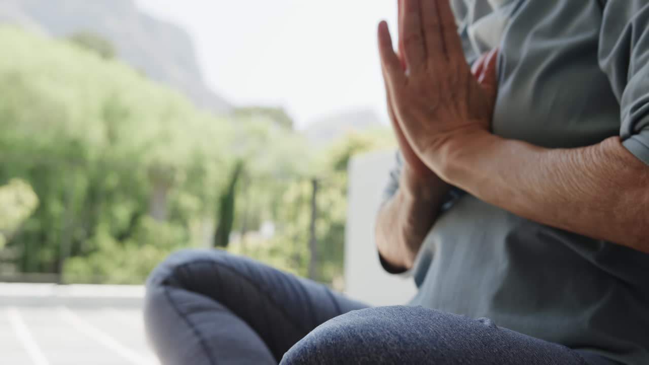 Meditating on balcony, senior woman practicing mindfulness in peaceful surroundings