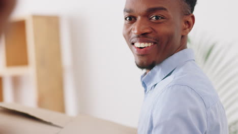 Black-man-and-woman-moving-boxes-in-new-house