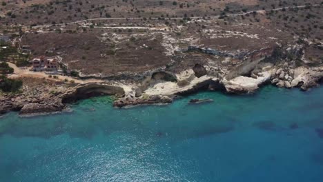 Establishing-drone-shot-of-Mani-Beach-in-Greece,-Pan-shot