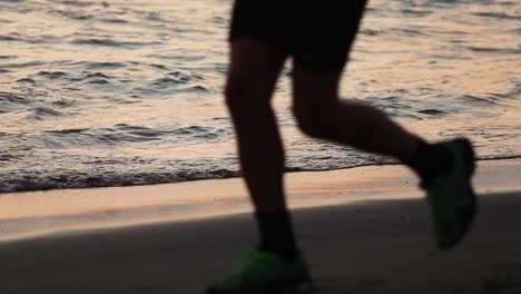 jogging on the beach near the waves during sunset, beautiful - slow motion