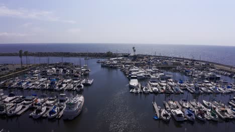 Low-aerial-close-up-shot-of-yachts-and-boats-in-their-slips-at-King-Harbor-Marina-in-Redondo-Beach,-California