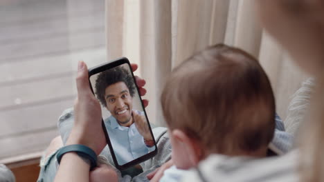 mother-and-baby-having-video-chat-with-father-using-smartphone-waving-at-infant-enjoying-communicating-with-family-on-mobile-phone-connection