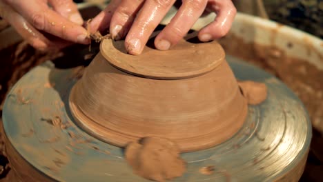 an overturned bowl spins on a potters wheel during final processing.