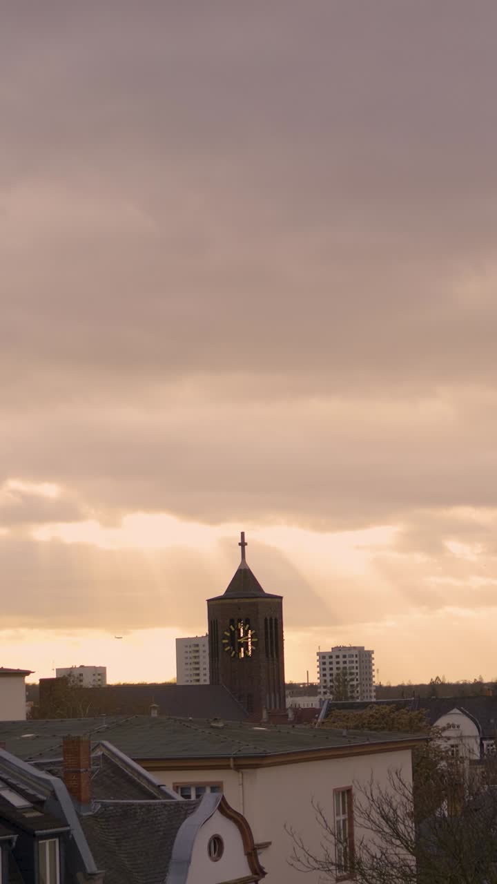 Frankfurt skyline with church under dramatic evening sky