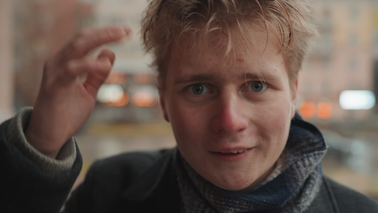 Intimate closeup of white creator adjusting beanie and hair, droplets on forehead, hands touching face, shifting gaze from doubt to quiet resolve, candid expressions, shallow focus bokeh, vlogger
