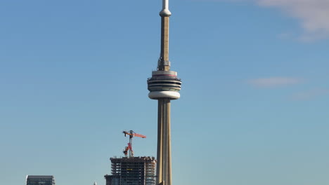 aerial view of the cn tower and a highrise under construction in toronto