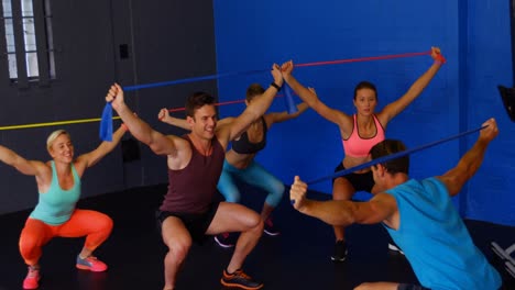 Group-of-people-performing-exercise-with-resistance-band-