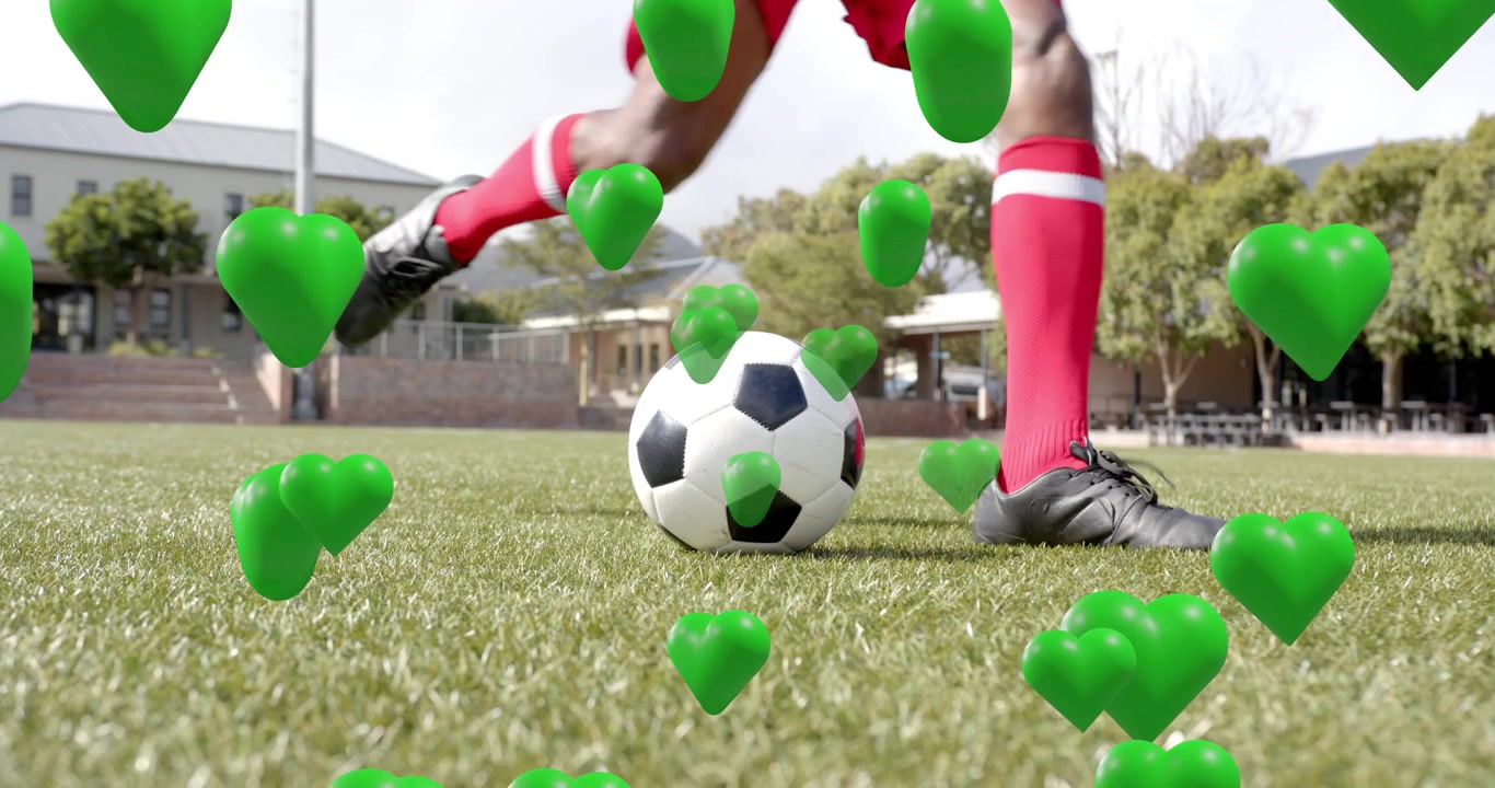 Mandlig atlet nærmer sig fodbold og viser tæmning og dribling med svævende hjerter til sport.