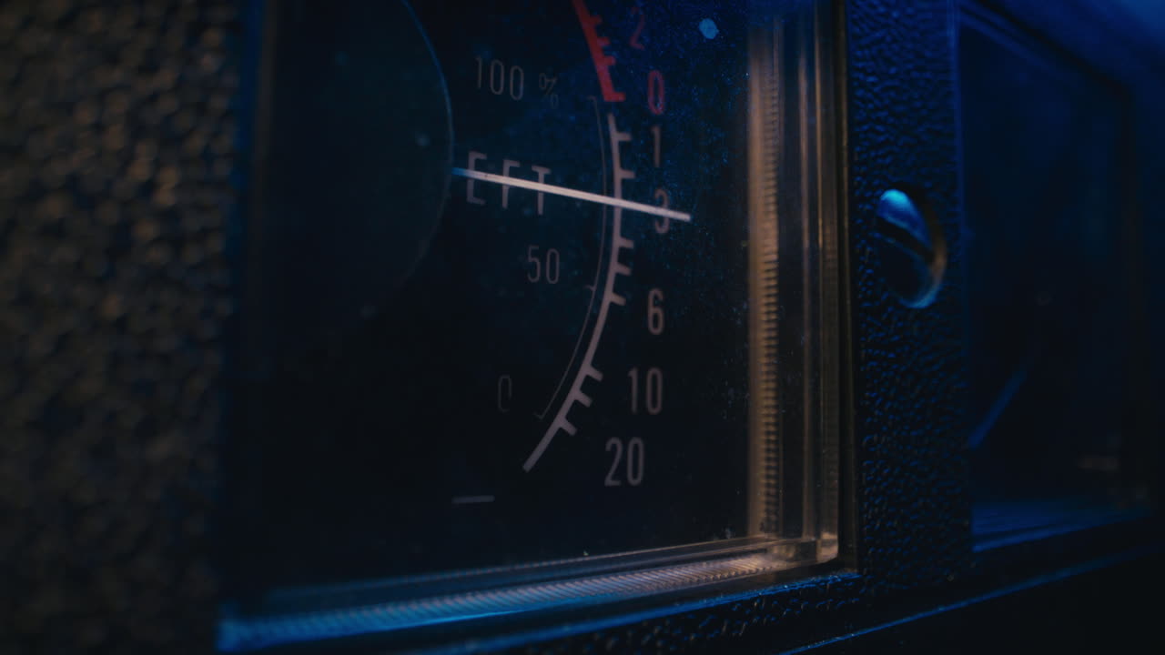 A close-up on a vintage tape recorder in a blue light