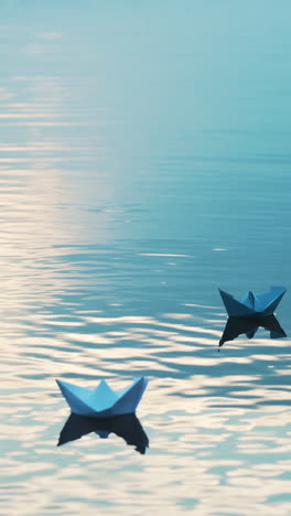 paper boats floating in the river. beautiful summer sunset. origami. vertical video