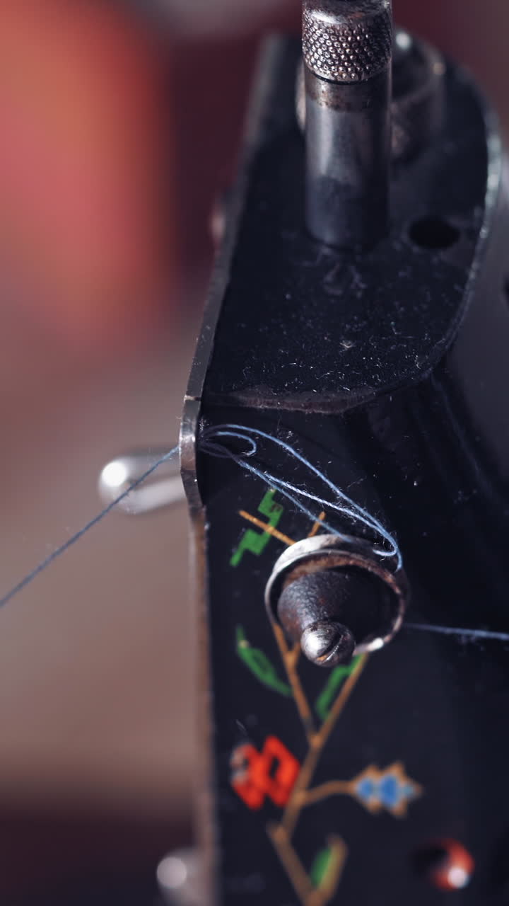 Old vintage hand sewing machine. Close up of woman put thread in needle Vertical video