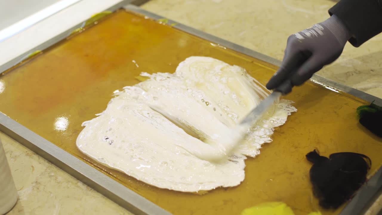 Manufacture of caramel candies stirring hot bubbling caramel