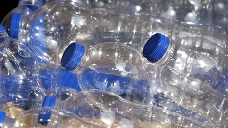 stack of clear plastic bottles with blue caps