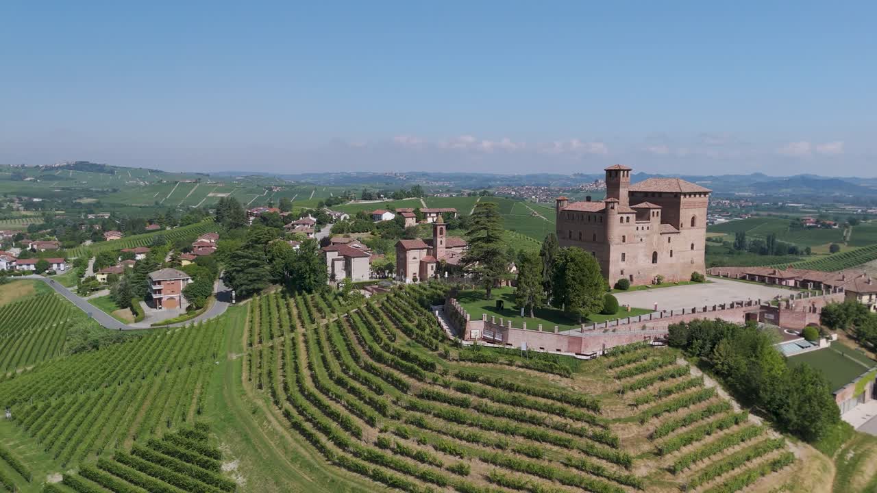 Grinzane Cavour castle, UNESCO site, Cuneo, Piedmont, Italy. 4k aerial view of the castle together with the Vineyard. Langhe-Roero and Monferrato. Flying forward with the castle on the right.