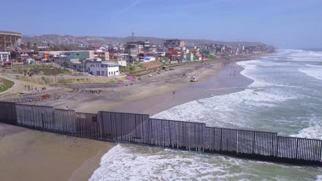 aerial of the us mexico border fence in the pacific ocean between san diego and tijuana 1