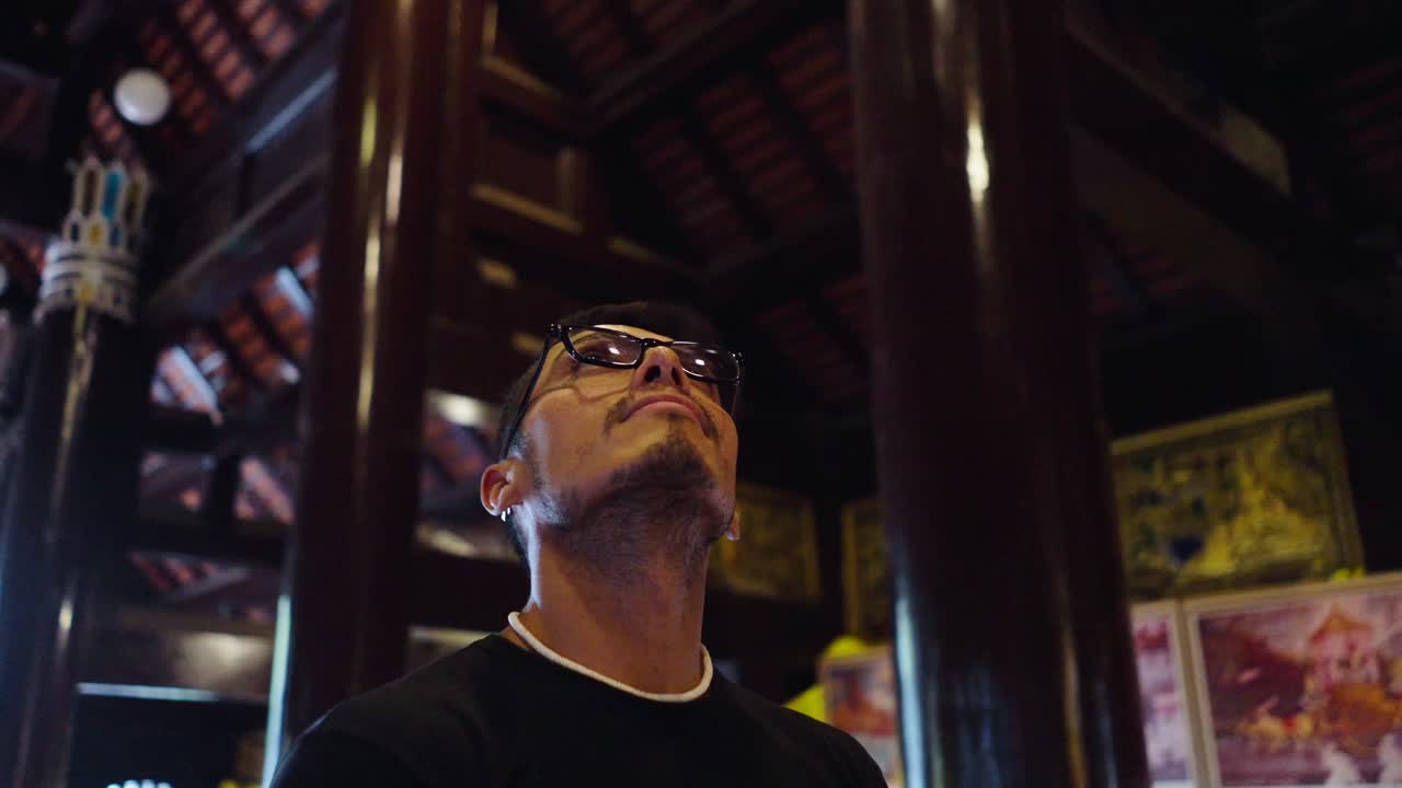 Man looking up at a temple interior