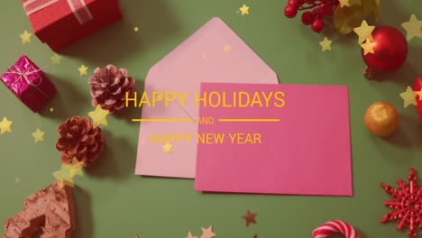 animation of christmas greetings text over envelopes and christmas decorations