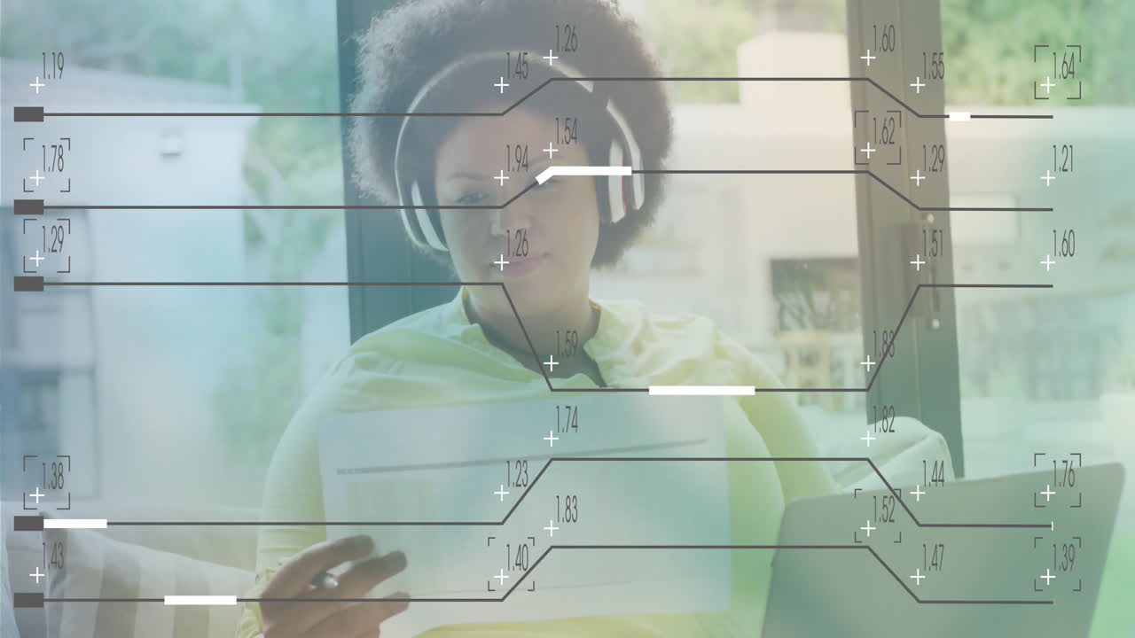 Person wearing headphones reading document with financial data animation overlay