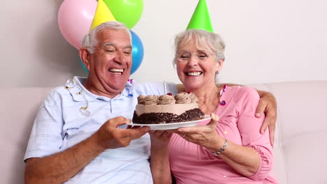 Senior-couple-celebrating-a-birthday-on-the-couch