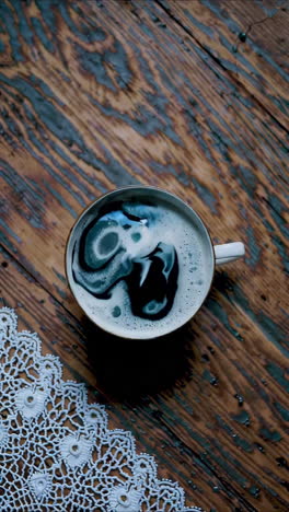 coffee cup on a wooden table with lace