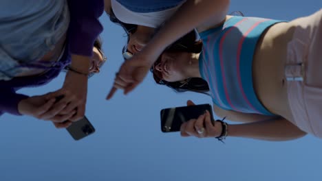 friends looking at smartphones