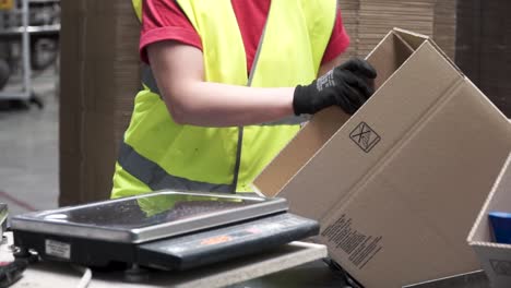 cardboard box handling and weighing in a warehouse