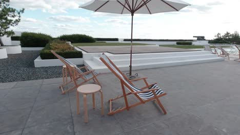 linen of empty chairs at backyard of beach house moving gently in the wind on a sunny day