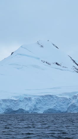 Winterliche-Küstenlandschaft-Mit-Eisgletscher-Und-Bergen,-Wunderschöne-Dramatische-Antarktische-Küstenlandschaft-Mit-Meer,-Ozean,-Schnee-Und-Eis,-Vertikales-Video-Für-Soziale-Medien,-Instagram-Reels-Und-Tiktok