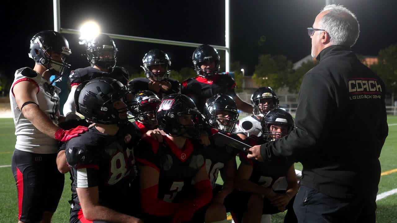 Football Team Huddle with Coach