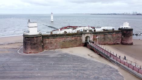 Fort-Perch-Rock-New-Brighton-sandstone-coastal-defence-battery-museum-aerial-view-descent