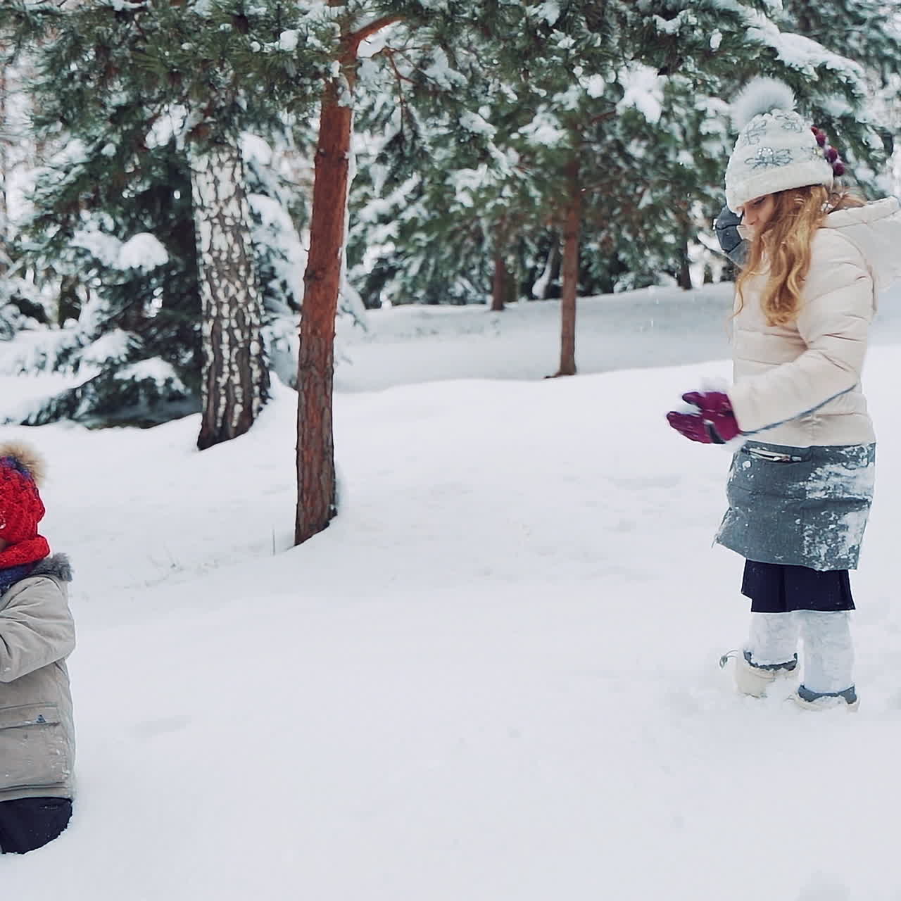 Child play outdoors in snow. Outdoor fun for family Christmas vacation.