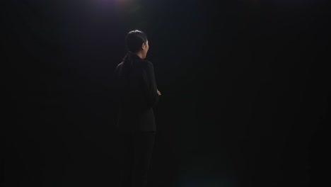 woman in business attire giving a presentation