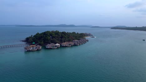 song saa private island, a luxury resort connecting two islands with a pier and overwater bungalows. stunning aerial view flight panorama overview drone