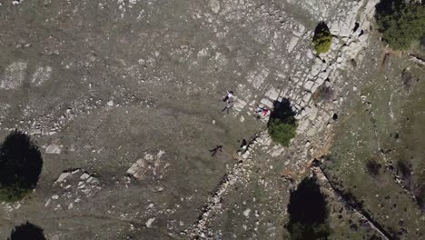 Aerial-view-of-friends-resting-lying-on-the-ground-in-the-mountain